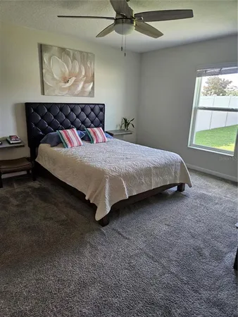 a bed sitting in a bedroom next to a window