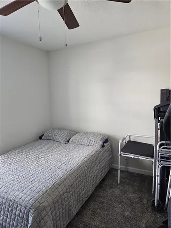 a bedroom with a bed and a book shelf