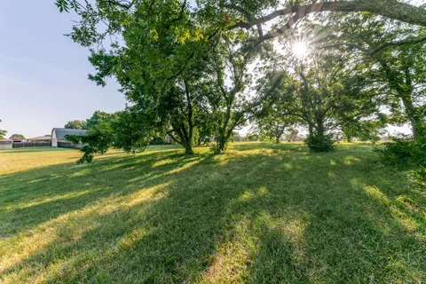 a view of yard with swimming pool and green space