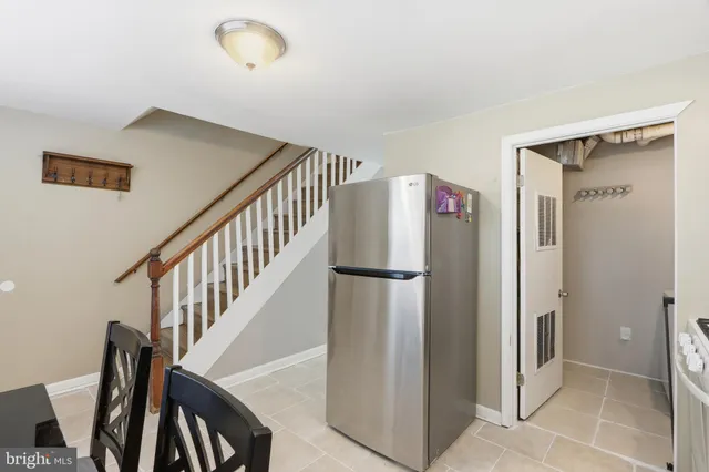 a view of staircase with wooden floor and fan