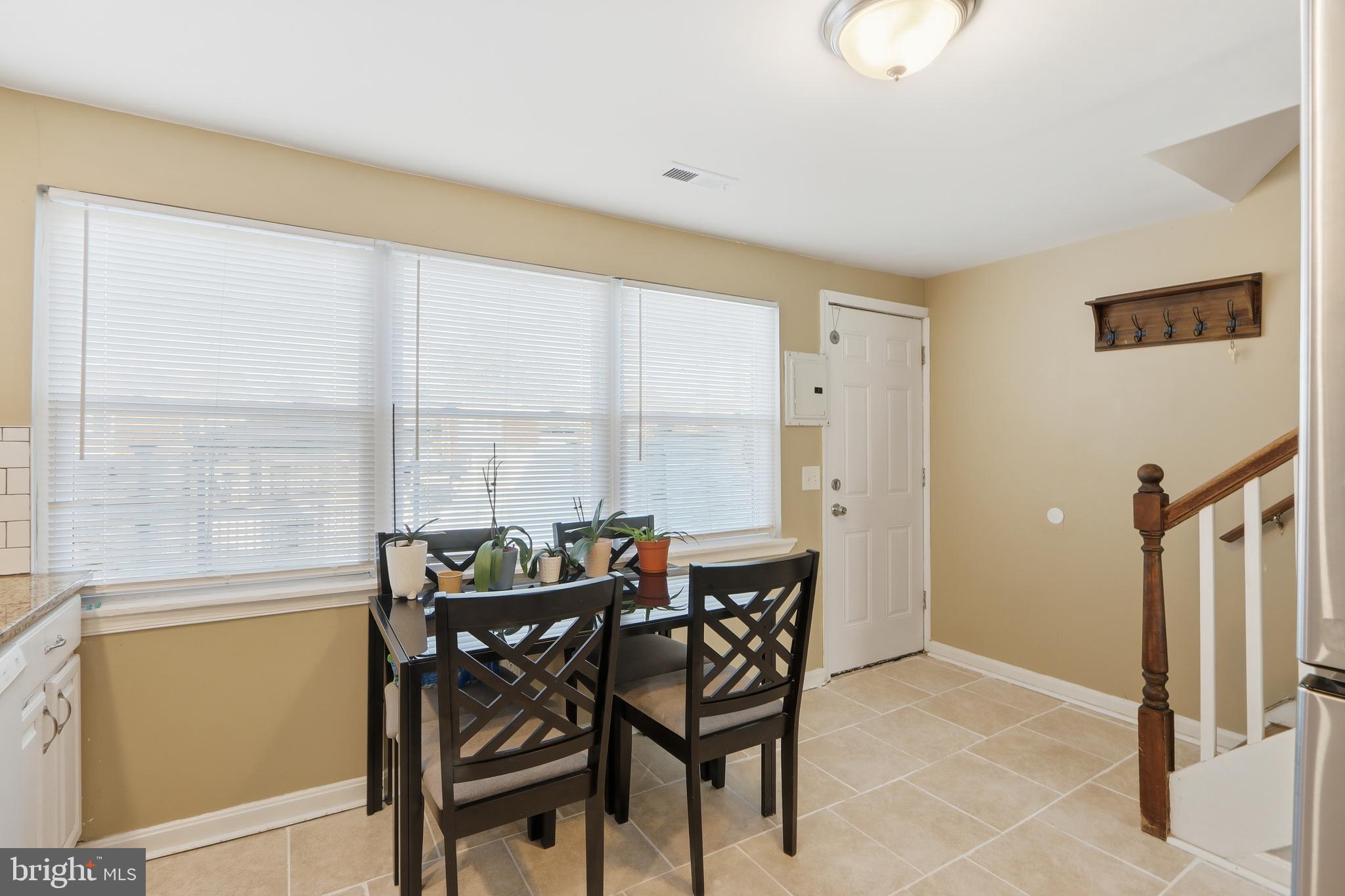 4432 Annapolis Road Baltimore, MD 21227 - Photo 16 of 31 a dining room with furniture and a floor to ceiling window
