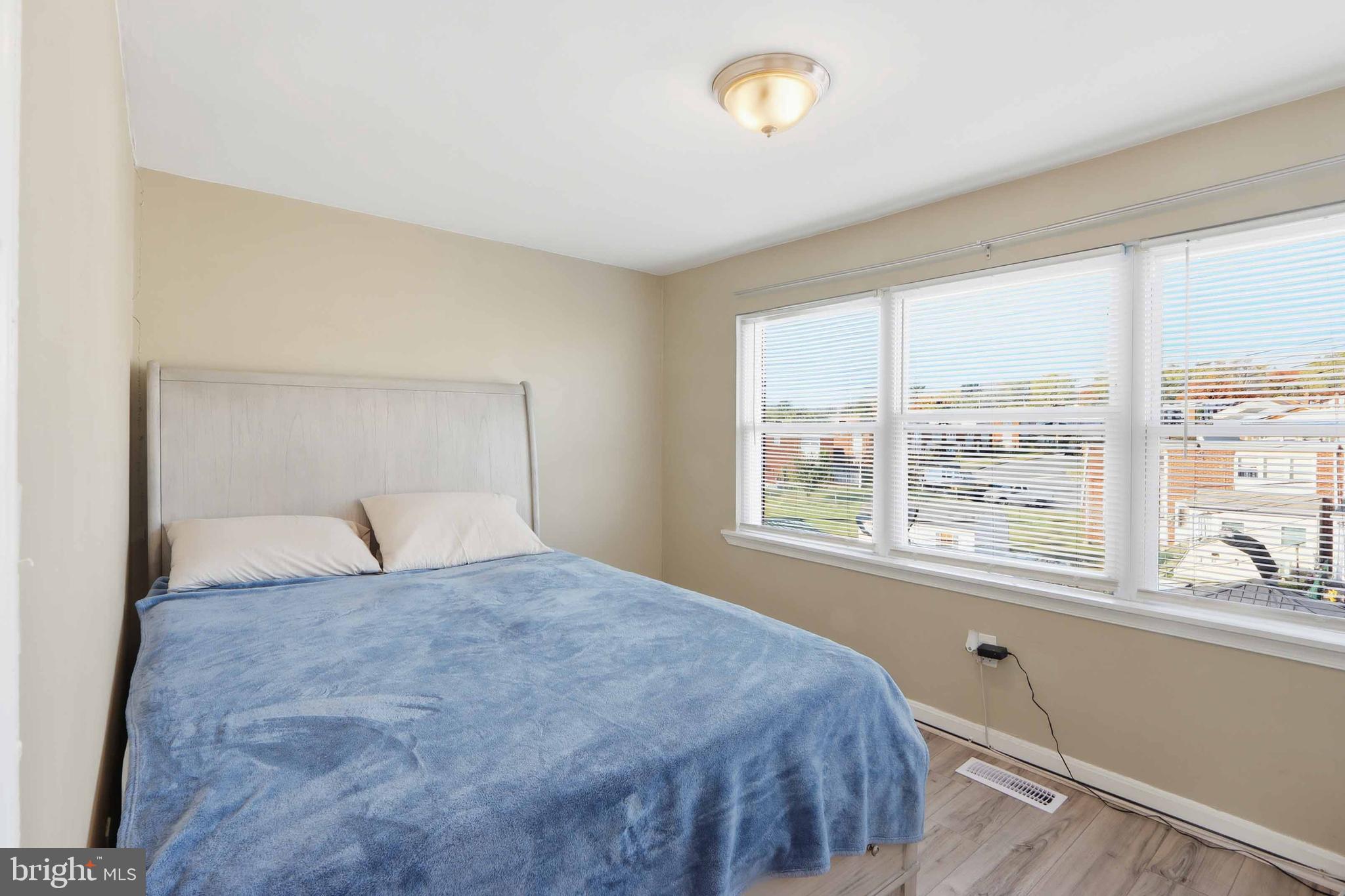 4432 Annapolis Road Baltimore, MD 21227 - Photo 19 of 31 a bedroom with a large bed and a large window