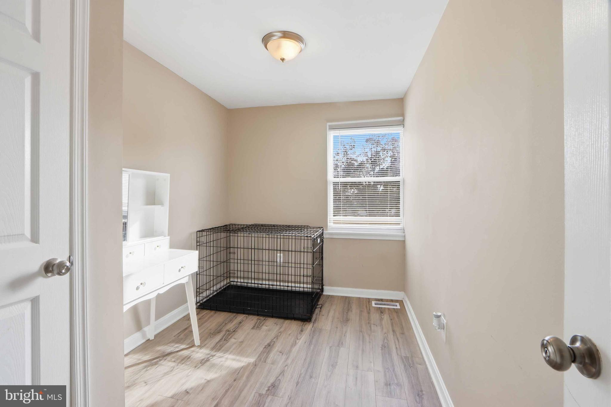 4432 Annapolis Road Baltimore, MD 21227 - Photo 23 of 31 a view of room with window and wooden floor