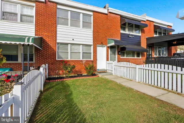 a view of a house with a yard and deck