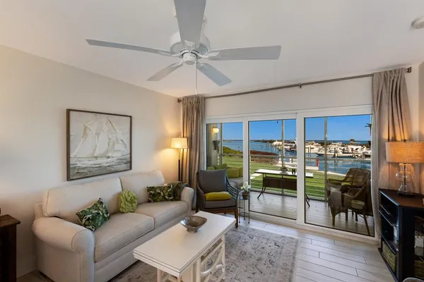 a living room with stainless steel appliances kitchen island granite countertop furniture and a view of kitchen