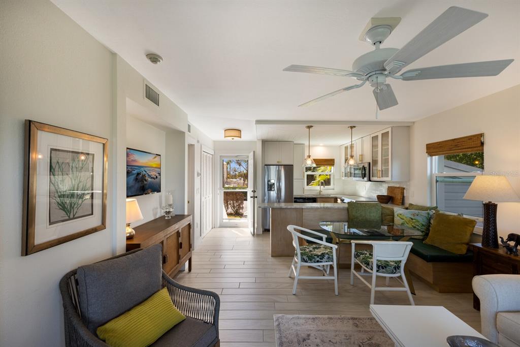 5850 Gasparilla Road, Unit M7 Boca Grande, FL 33921 - Photo 14 of 54 a view of a dining room with furniture and wooden floor