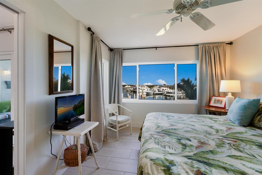 5850 Gasparilla Road, Unit M7 Boca Grande, FL 33921 - Photo 16 of 54 a bedroom with a bed and a view of kitchen