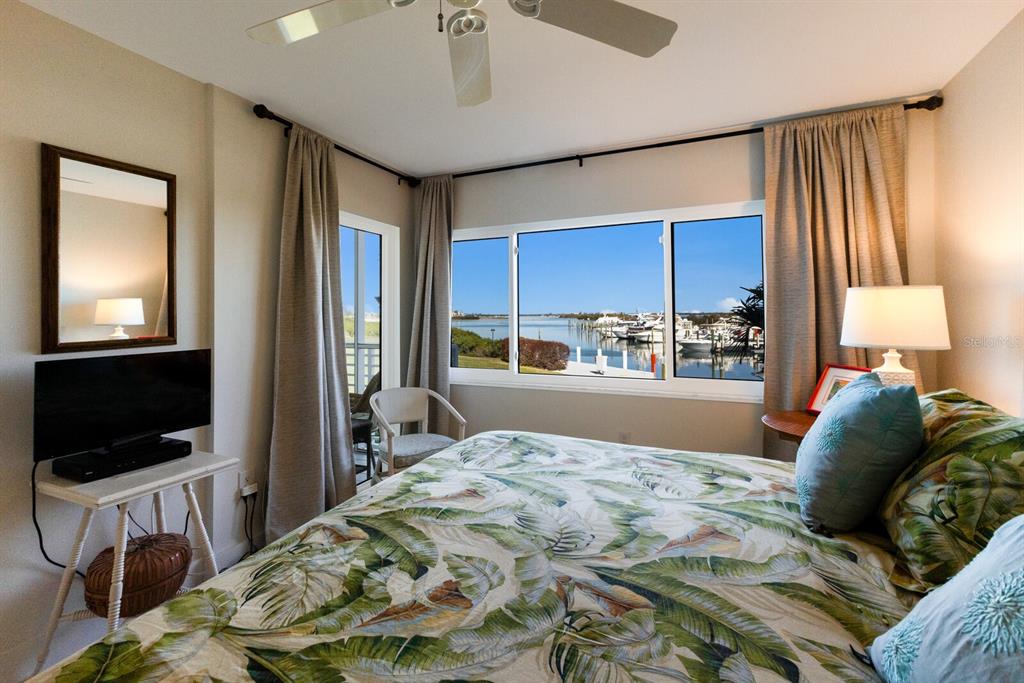 5850 Gasparilla Road, Unit M7 Boca Grande, FL 33921 - Photo 17 of 54 a bedroom with a bed and a flat screen tv