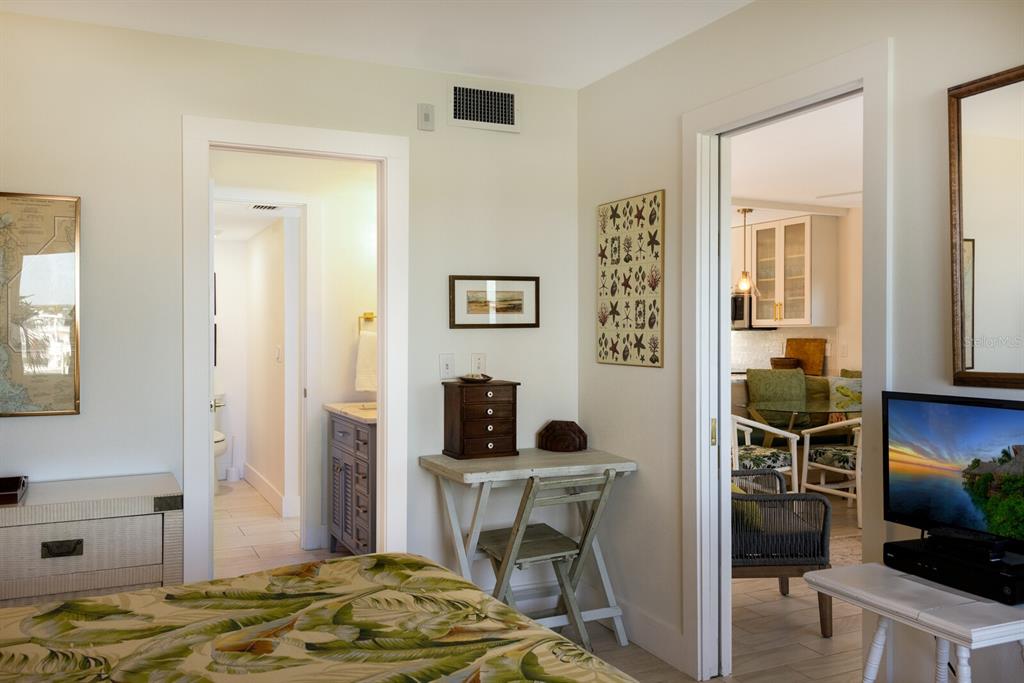 5850 Gasparilla Road, Unit M7 Boca Grande, FL 33921 - Photo 18 of 54 a bedroom with a bed and a table in it