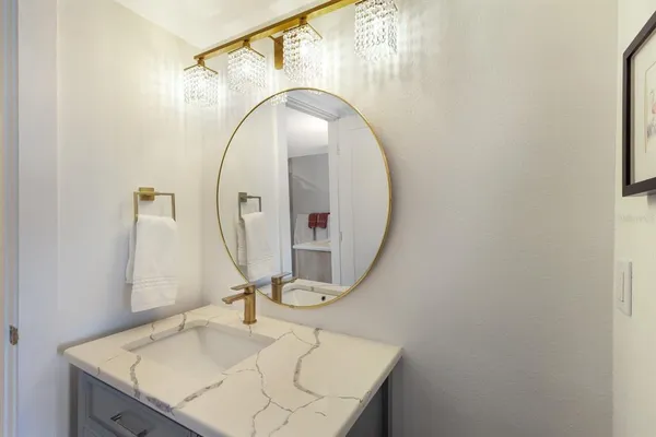 a bathroom with a sink vanity and a mirror