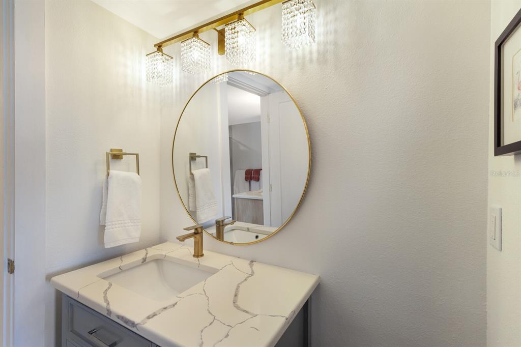 5850 Gasparilla Road, Unit M7 Boca Grande, FL 33921 - Photo 19 of 54 a bathroom with a sink vanity and a mirror
