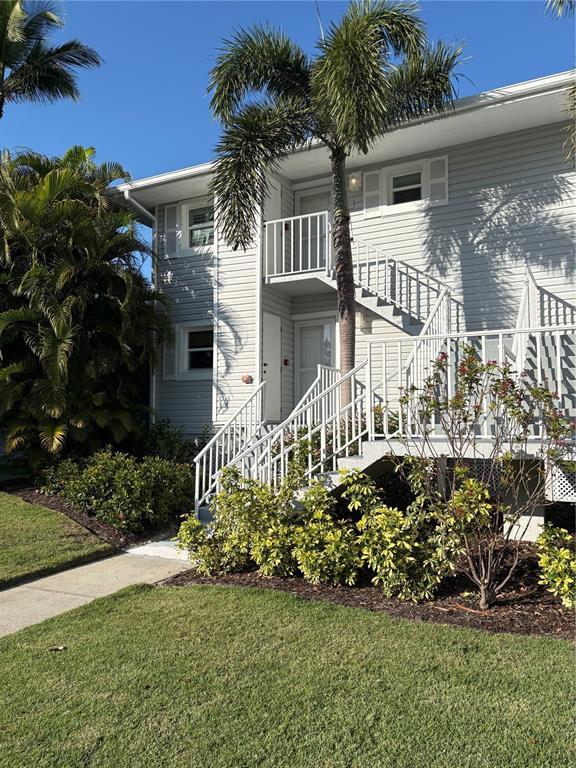 5850 Gasparilla Road, Unit M7 Boca Grande, FL 33921 - Photo 2 of 54 a front view of a house with a garden