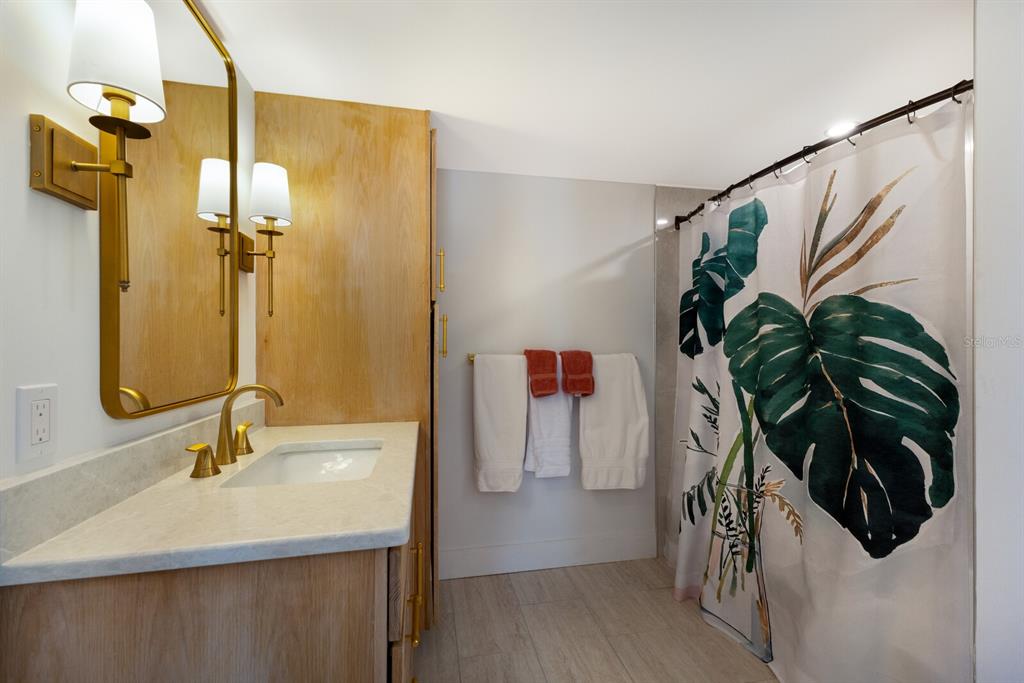 5850 Gasparilla Road, Unit M7 Boca Grande, FL 33921 - Photo 21 of 54 a bathroom with a sink and a mirror