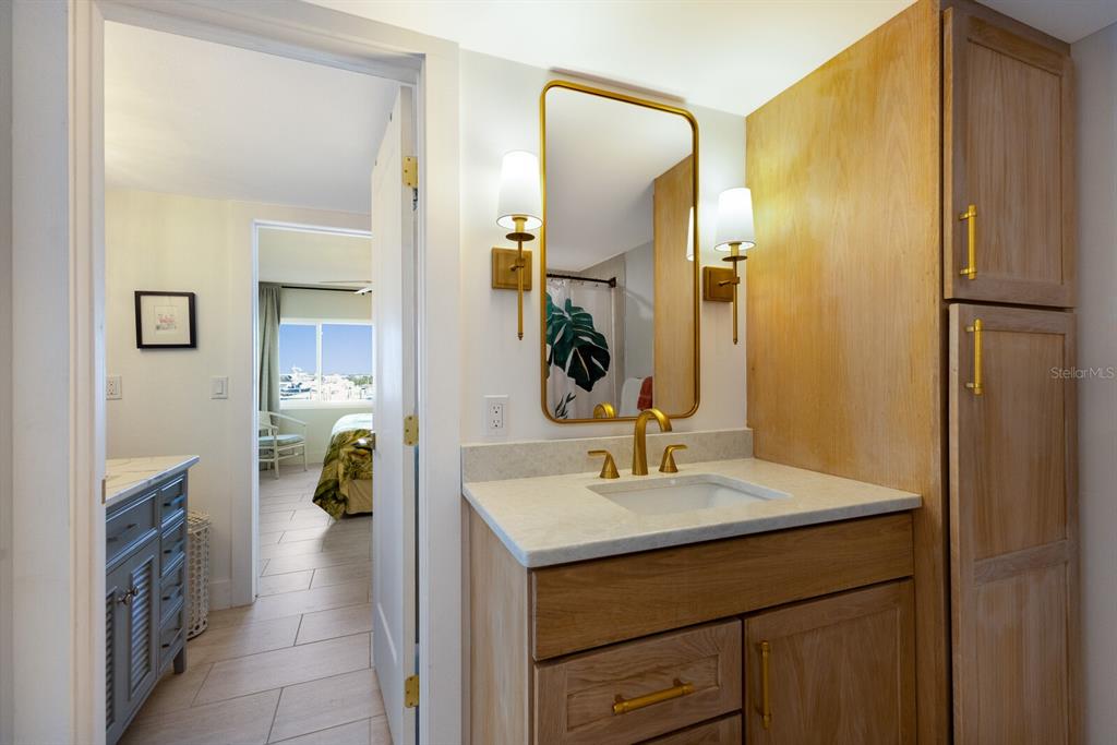 5850 Gasparilla Road, Unit M7 Boca Grande, FL 33921 - Photo 22 of 54 a en suite bathroom with a sink and a mirror
