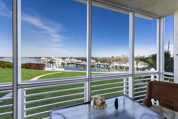 a view of a deck with a floor to ceiling window and wooden fence