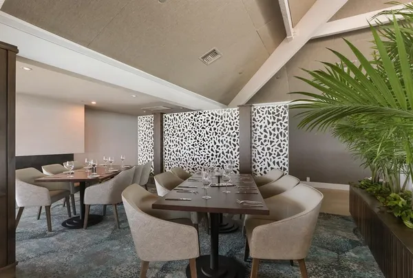 a view of a dining room with furniture and window