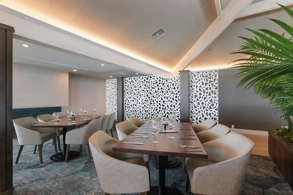 a dining room with furniture and wooden floor