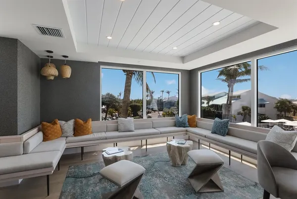 a living room with lots of furniture and a large window