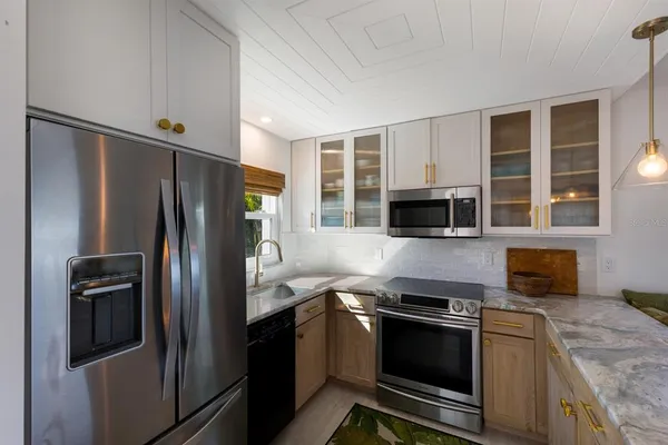 a kitchen with stainless steel appliances granite countertop a refrigerator and a stove