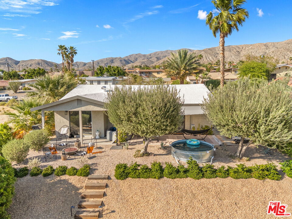 66869 San Ardo Road Desert Hot Springs, CA 92240 - Photo 1 of 39 a front view of a building with garden