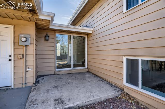 1320 Wooten Road Colorado Springs, CO 80915 - Photo 24 of 26 Walkout from entry to backyard