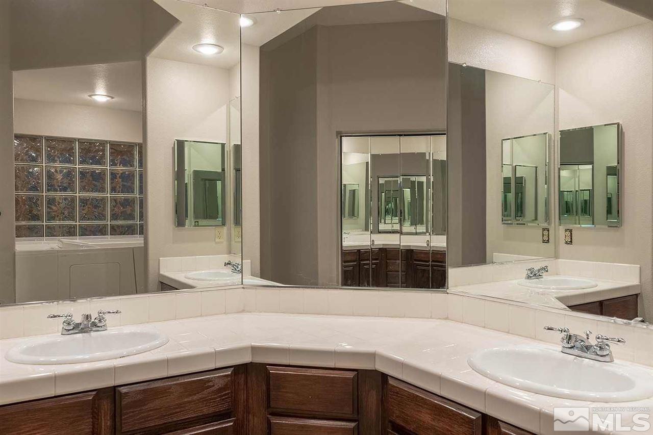 2969 Mountain Springs Road Reno, NV 89519 - Photo 17 of 25 a bathroom with a sink and a large mirror