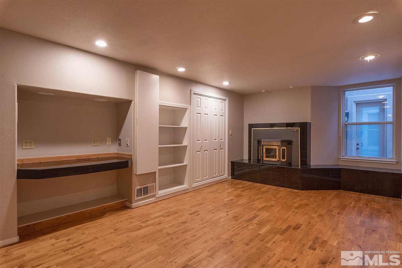 2969 Mountain Springs Road Reno, NV 89519 - Photo 19 of 25 a view of empty room with a fireplace and wooden floor