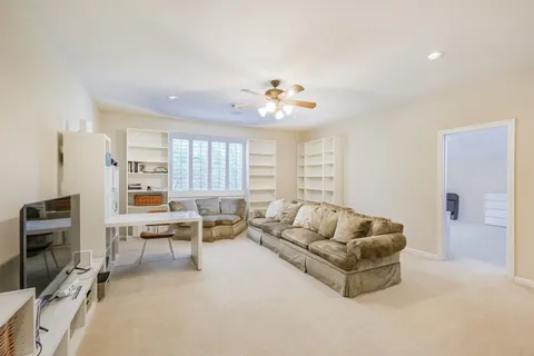 a living room with furniture a table and a window