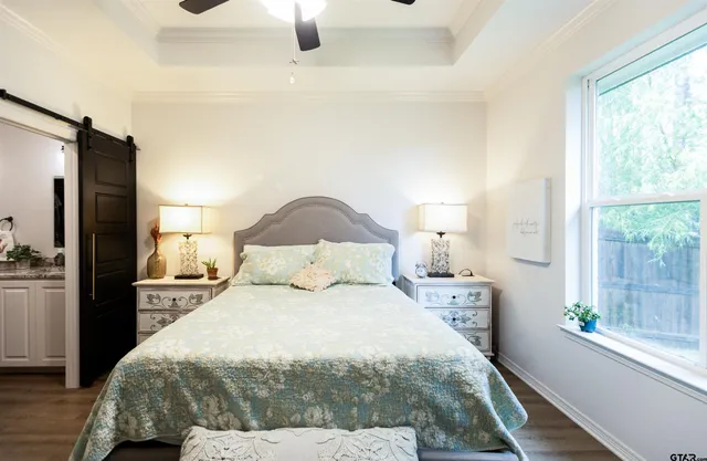 a large bed sitting in a bedroom next to a window