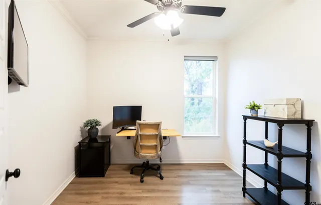 a view of a workspace with furniture and a window