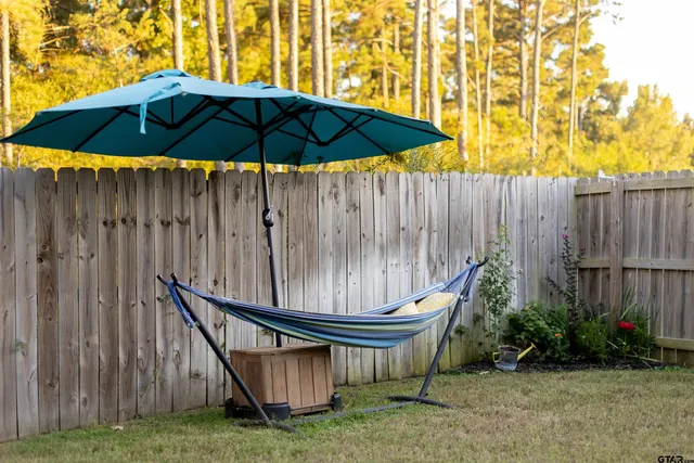 a backyard of a house with table and chairs