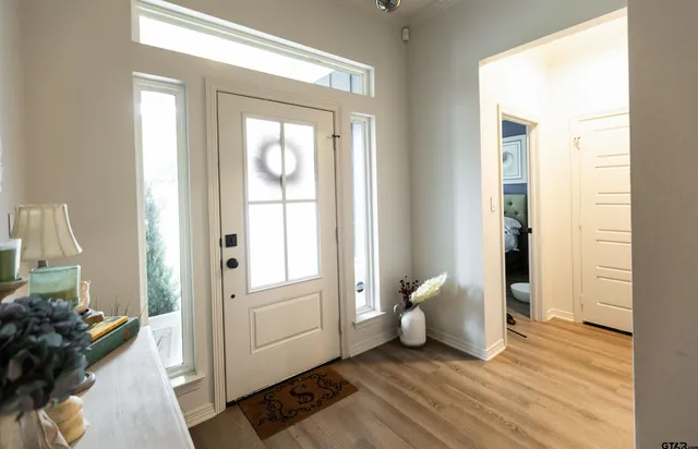 a view of an entryway with wooden floor and a livingroom