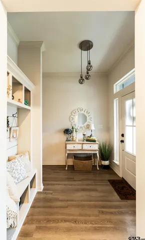 a view of a bedroom with a bed and wooden floor