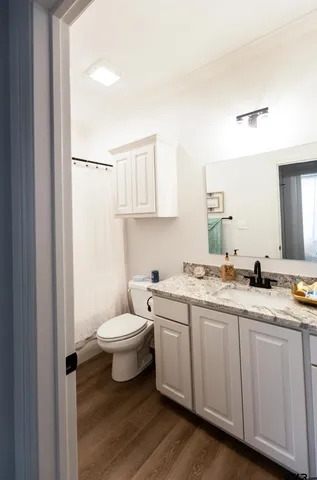 a bathroom with a toilet a sink and mirror
