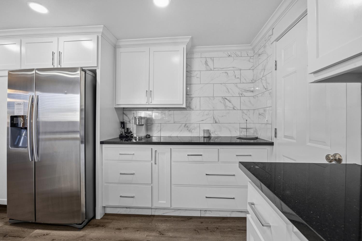 29205 Road 210 Exeter, CA 93221 - Photo 17 of 44 a kitchen with granite countertop a refrigerator and a sink