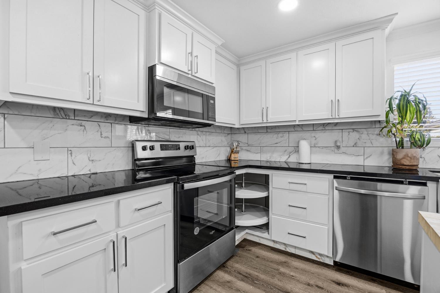 29205 Road 210 Exeter, CA 93221 - Photo 18 of 44 a kitchen with white cabinets and appliances