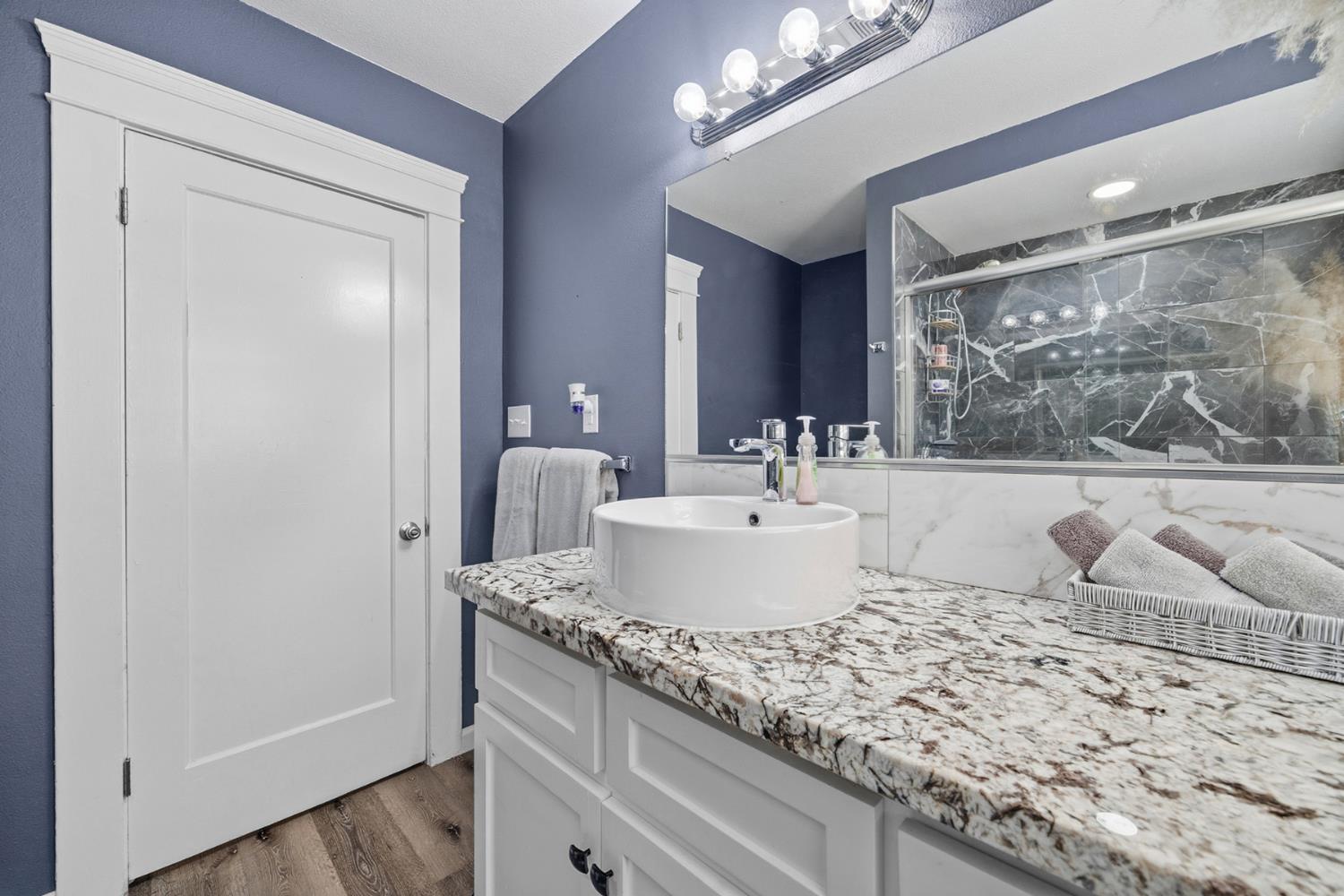 29205 Road 210 Exeter, CA 93221 - Photo 23 of 44 a bathroom with a granite countertop sink and a mirror