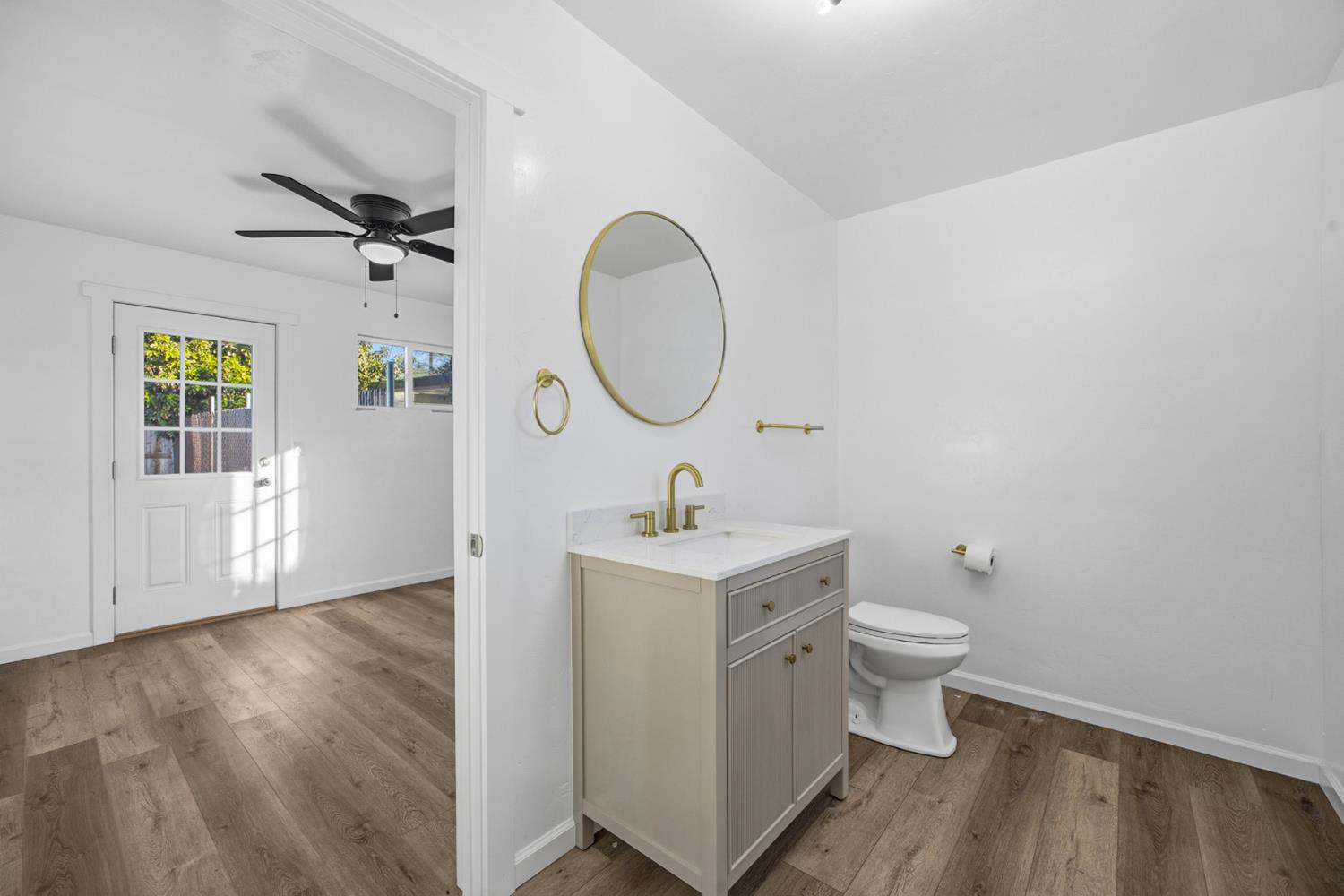 29205 Road 210 Exeter, CA 93221 - Photo 39 of 44 a bathroom with a toilet a sink and a mirror