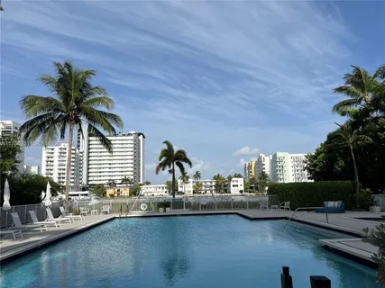 a view of a house with pool and chairs