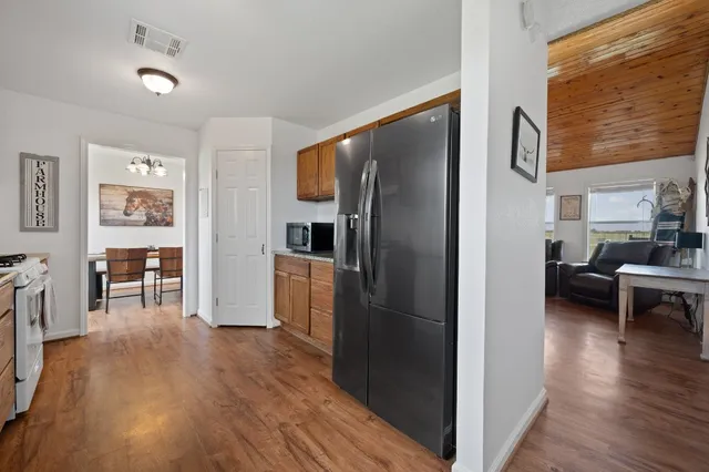 a kitchen with stainless steel appliances granite countertop a refrigerator and a stove top oven