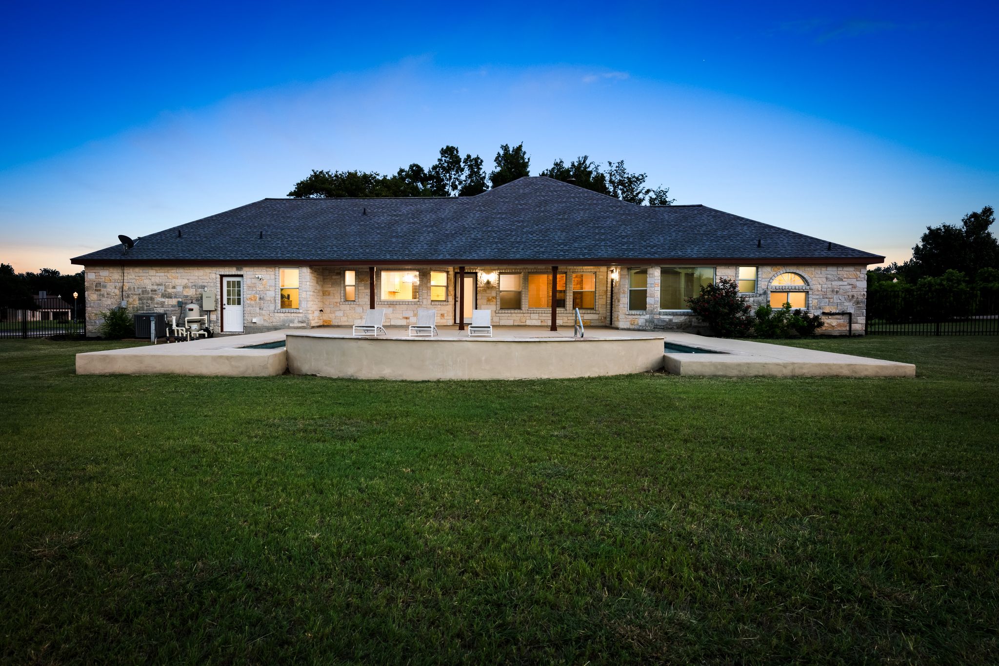 110 Starlight Trail Georgetown, TX 78633 - Photo 32 of 36 Back of property with stone siding and a patio area