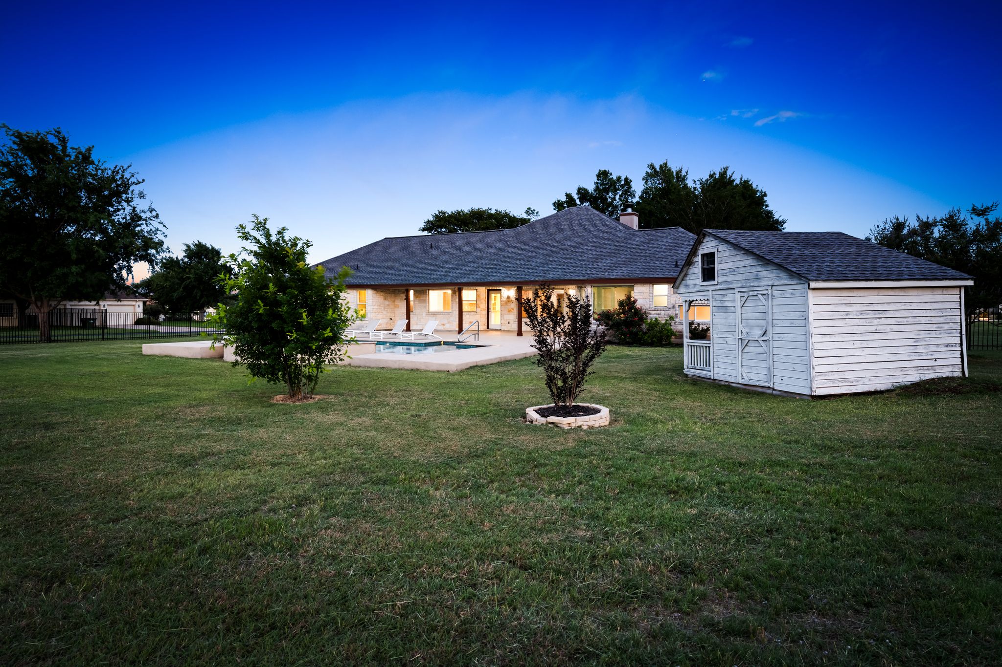 110 Starlight Trail Georgetown, TX 78633 - Photo 33 of 36 Expansive backyard with bonus storage shed and glowing poolside views