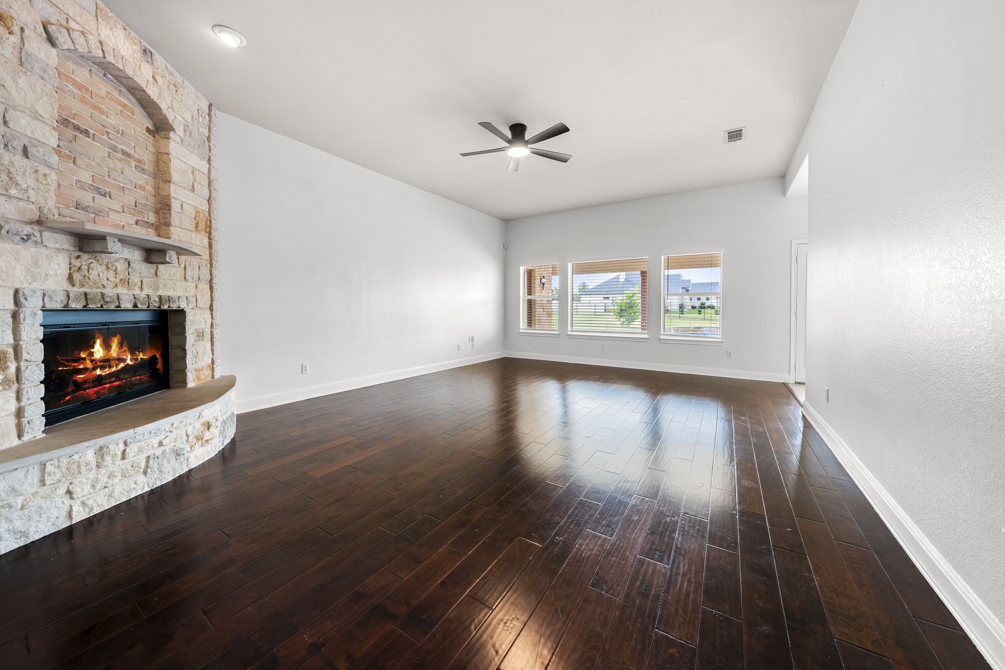 110 Starlight Trail Georgetown, TX 78633 - Photo 7 of 36 Warm wood floors and a striking stone fireplace anchor this inviting space