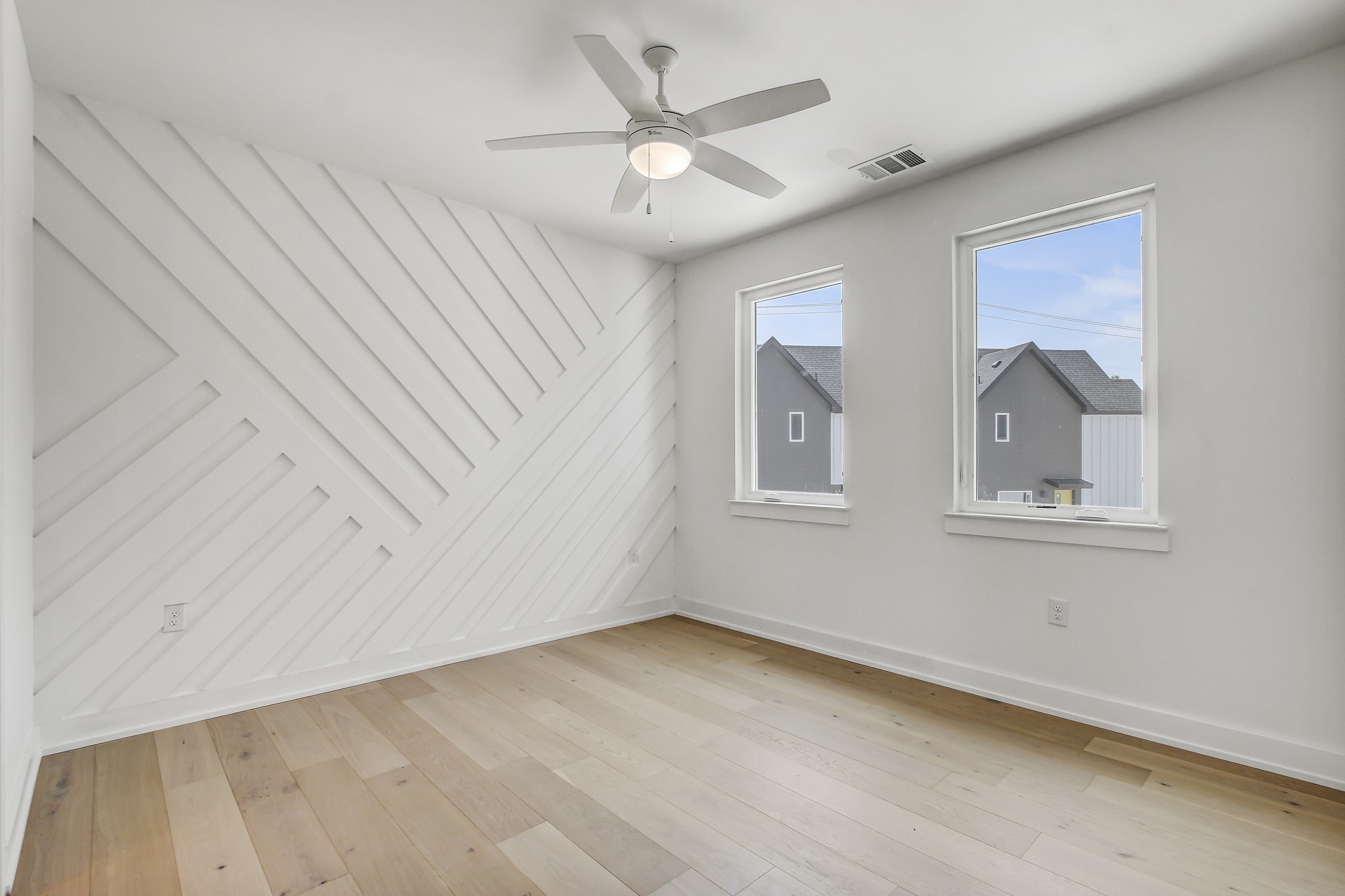4127 East 12th Street, Unit 3 Austin, TX 78721 - Photo 15 of 29 Spare room featuring baseboards, light wood finished floors, and a ceiling fan