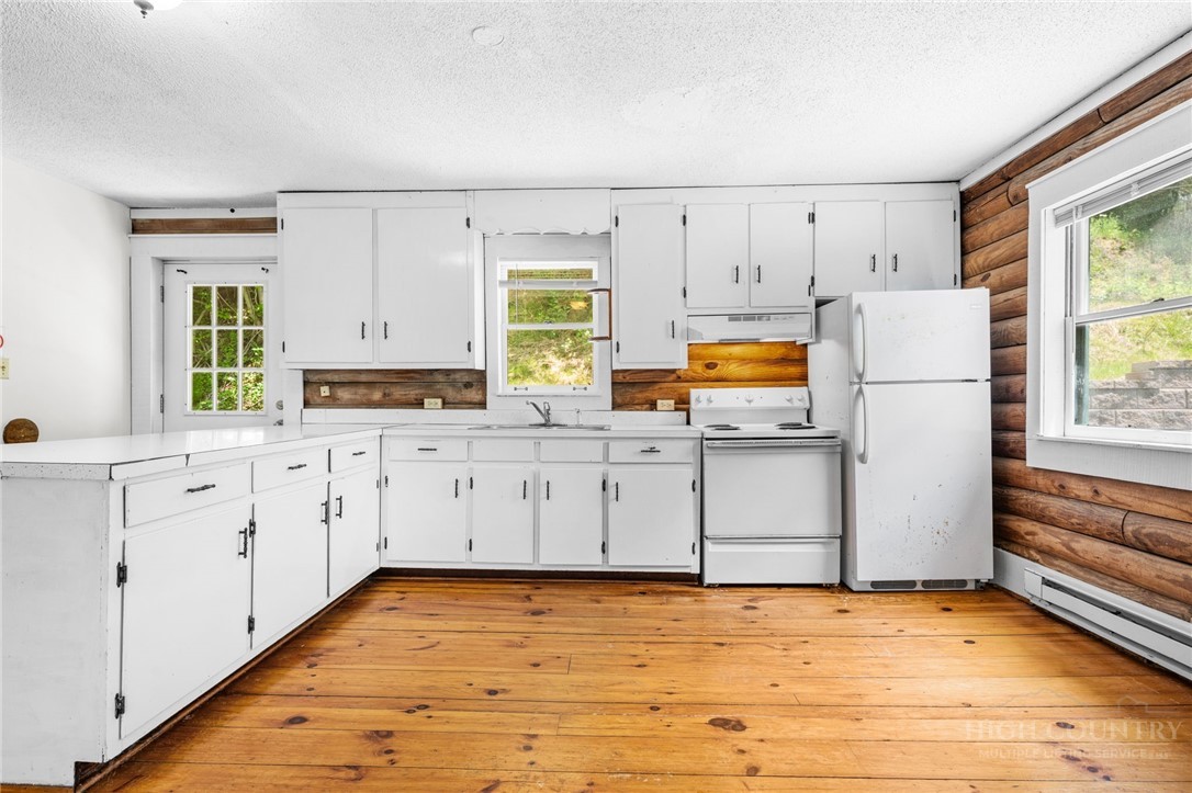 233 Alpine Acres Road Vilas, NC 28692 - Photo 8 of 32 a view of a kitchen with wooden floor and electronic appliances