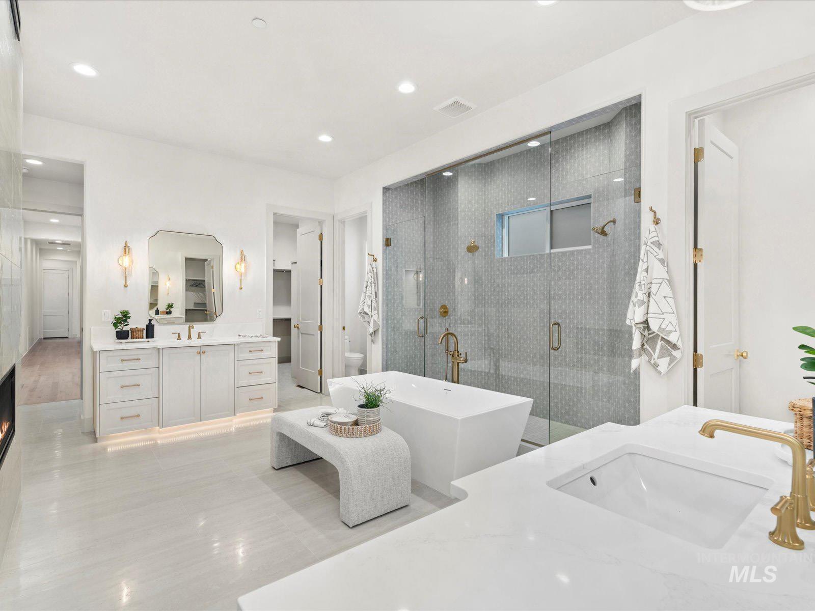 6161 East Prominence Court Boise, ID 83716 - Photo 15 of 45 Full bath with two vanities, a stall shower, and a freestanding bath