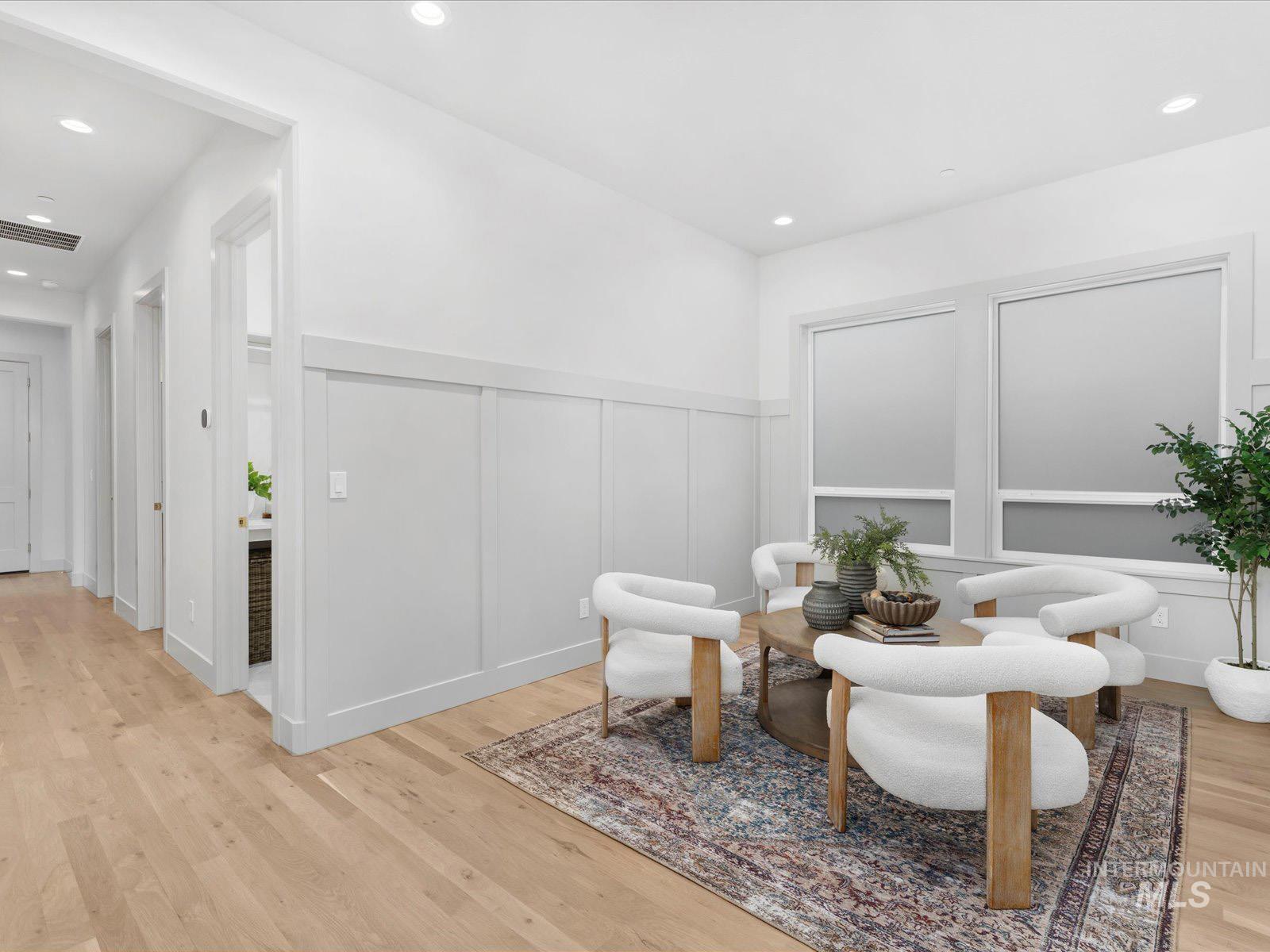6161 East Prominence Court Boise, ID 83716 - Photo 20 of 45 Living area featuring a decorative wall, wainscoting, light wood-style flooring, and recessed lighting