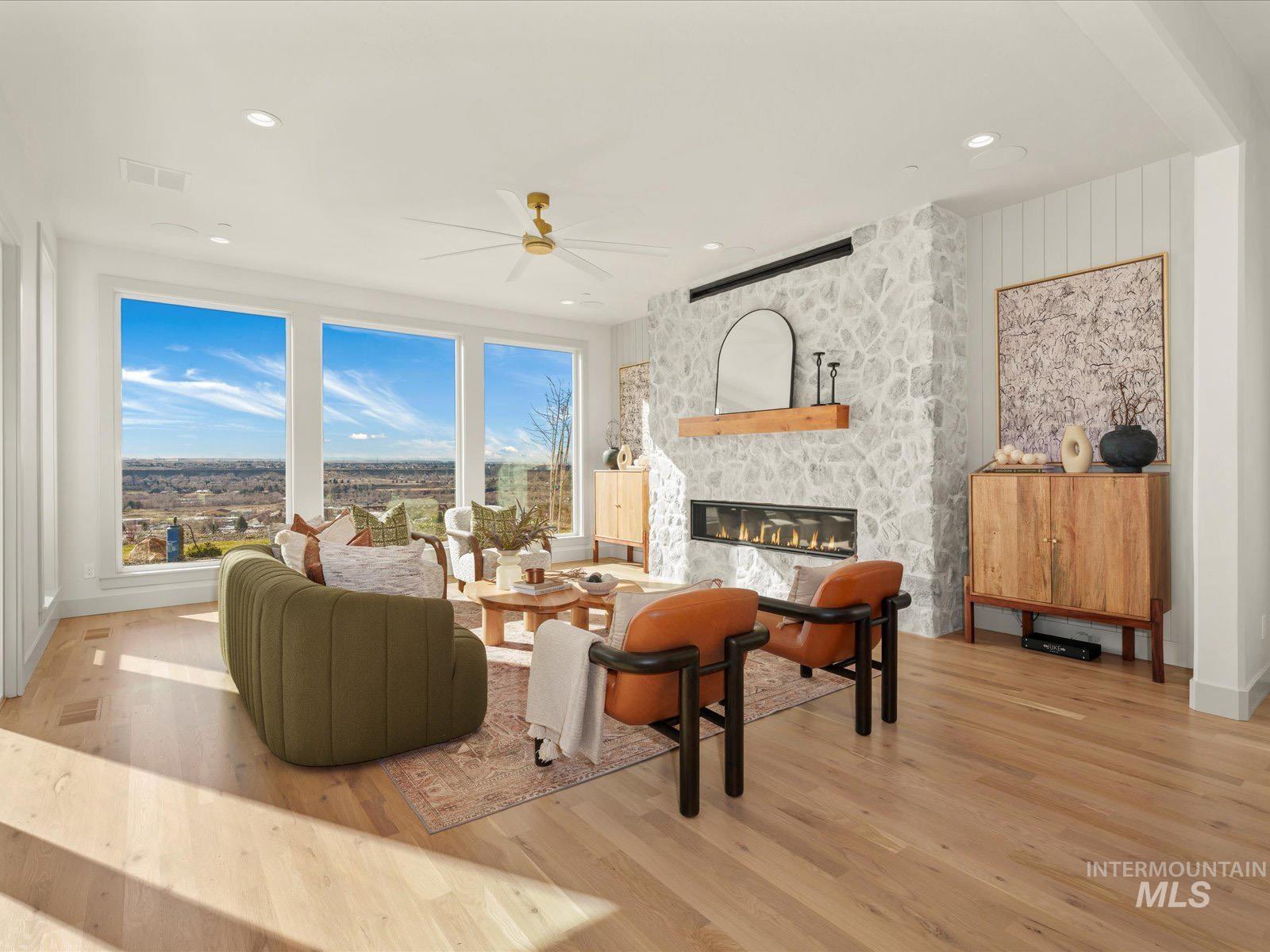 6161 East Prominence Court Boise, ID 83716 - Photo 3 of 45 Living room featuring light wood finished floors, a ceiling fan, a fireplace, and recessed lighting