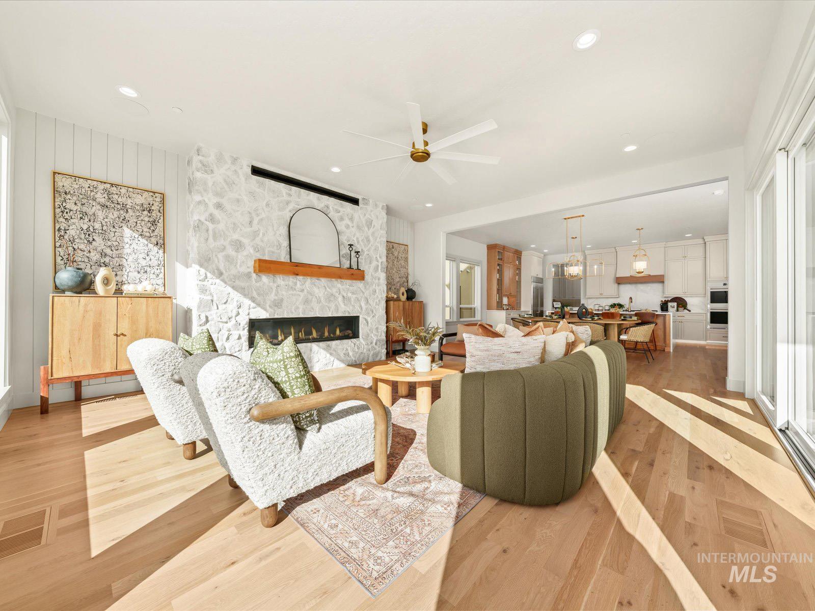 6161 East Prominence Court Boise, ID 83716 - Photo 5 of 45 Living room with light wood-style flooring, a ceiling fan, a fireplace, and recessed lighting