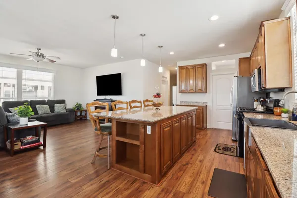 a kitchen with a stove and a wooden floor